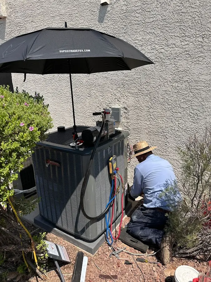 HVAC technician performing outdoor AC maintenance in Federal Way