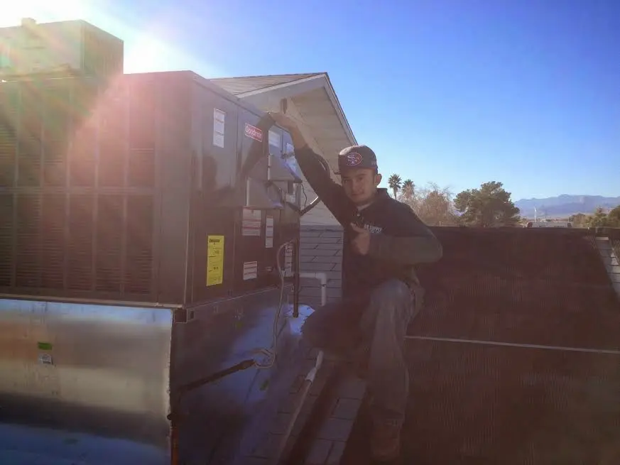 HVAC technician performing Boiler Repair on a rooftop unit in Federal Way